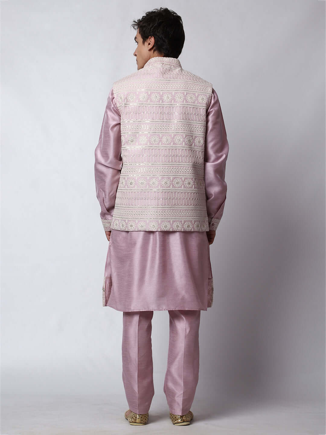 Mauve kurta with mauve nehru jacket for men which is made up of dupion silk and has net embroidery with sequins on it. Shop this mauve designer wedding kurta jacket set for male from Crease India website.