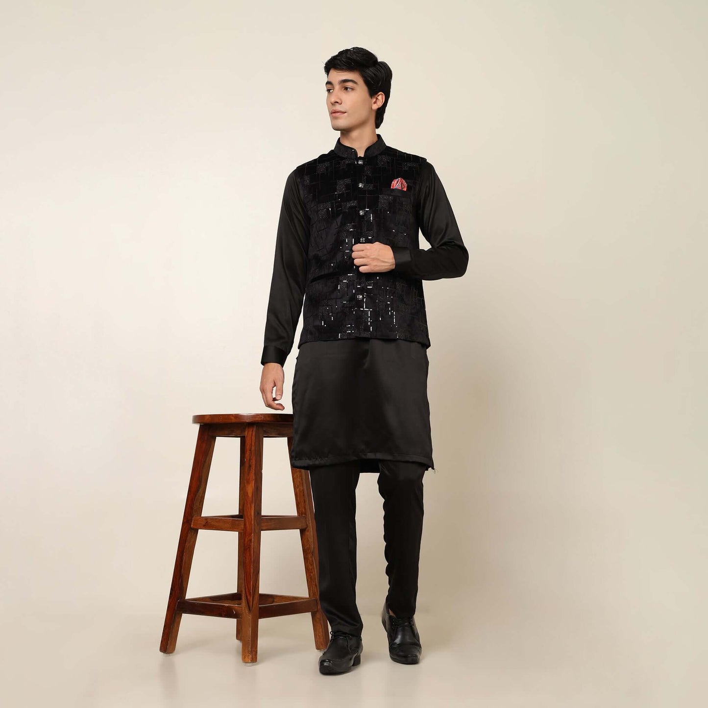 Black kurta with black nehru jacket for men which is made up of suede and has sequence embroidery on it. Shop this black designer wedding kurta jacket set for male from Crease India website.