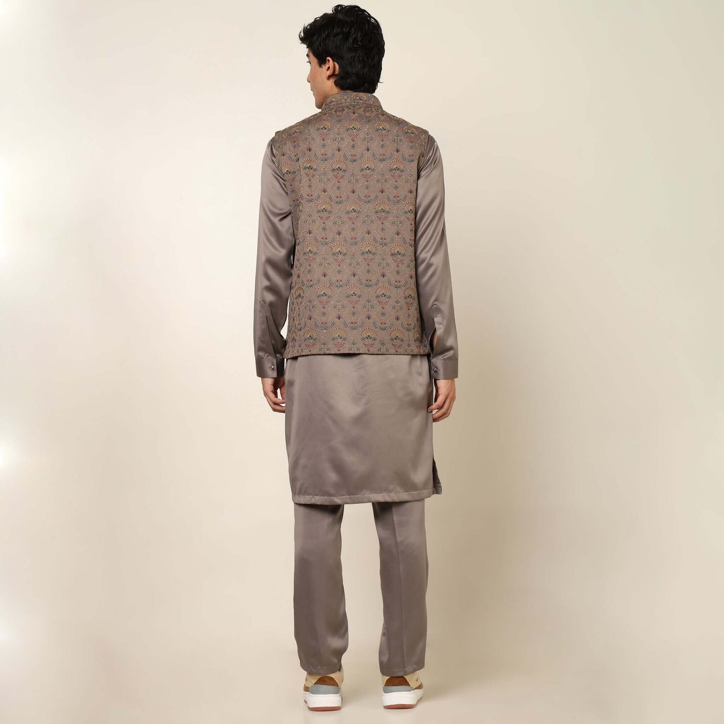Beige kurta with nehru jacket for men which is made up of satin and has multicolored embroidery on it. Shop this beige designer wedding kurta jacket set for male from Crease India website.