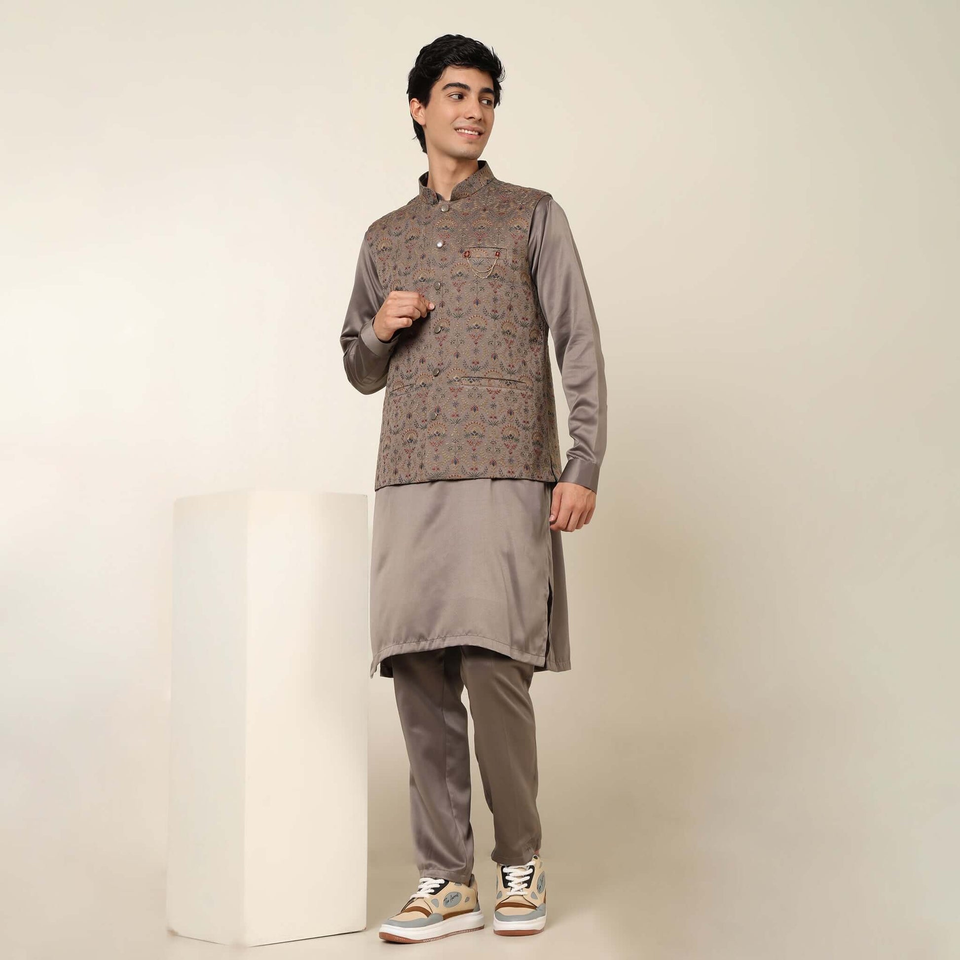 Beige kurta with nehru jacket for men which is made up of satin and has multicolored embroidery on it. Shop this beige designer wedding kurta jacket set for male from Crease India website.