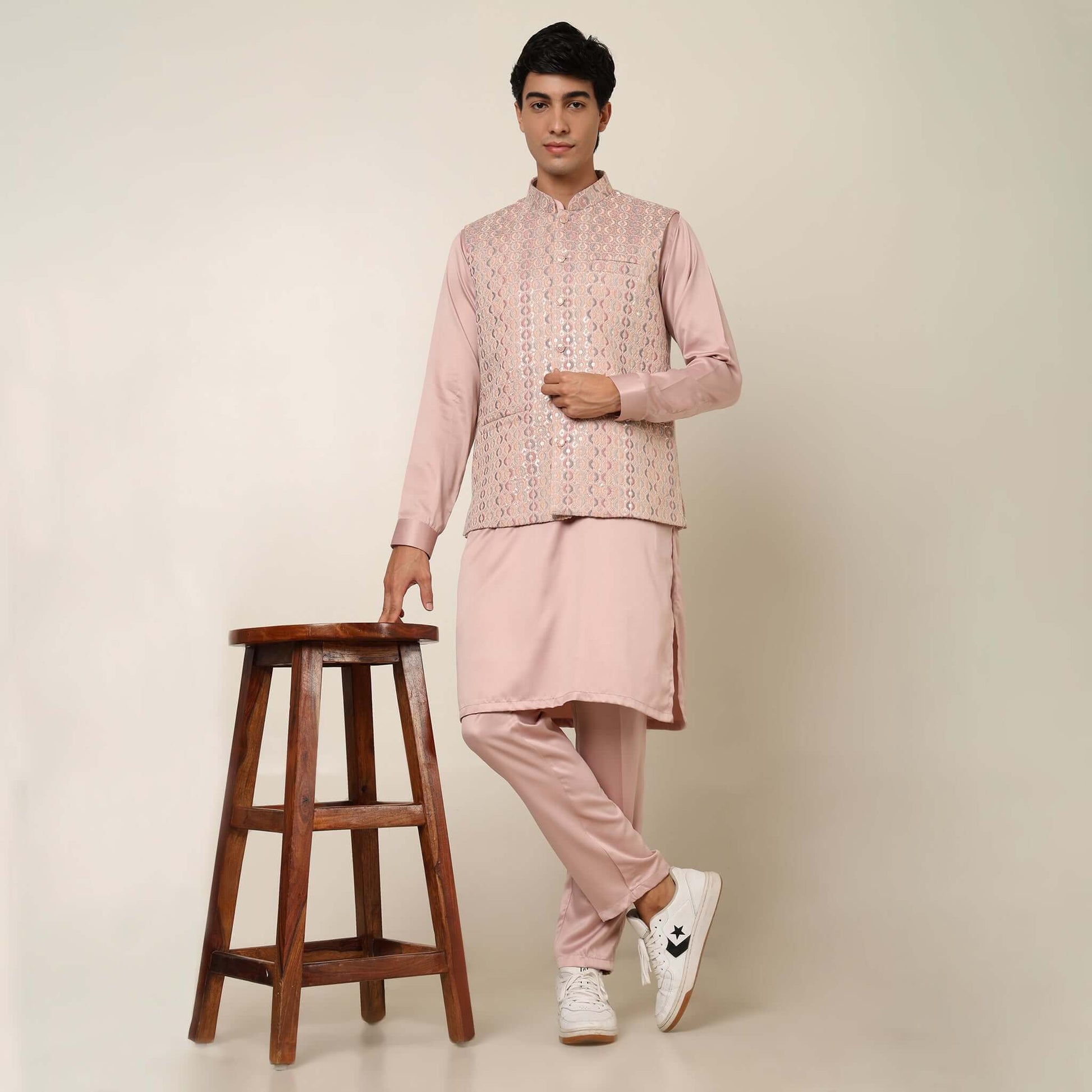 Peach kurta with nehru jacket for men which is made up of satin and has embroidery on it. Shop this peach designer wedding kurta jacket set for male from Crease India website.