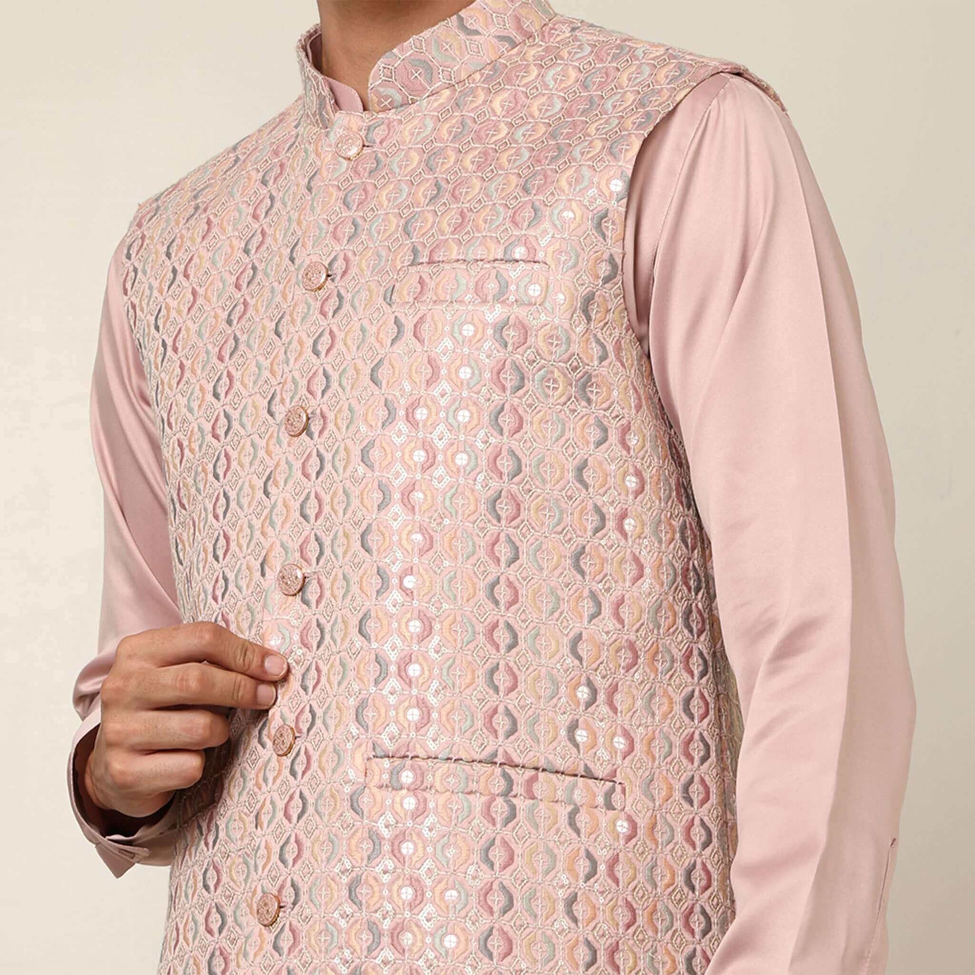 Peach kurta with nehru jacket for men which is made up of satin and has embroidery on it. Shop this peach designer wedding kurta jacket set for male from Crease India website.