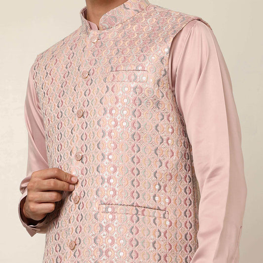 Peach kurta with nehru jacket for men which is made up of satin and has embroidery on it. Shop this peach designer wedding kurta jacket set for male from Crease India website.