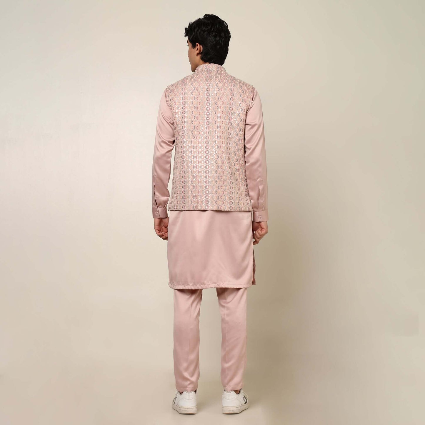 Peach kurta with nehru jacket for men which is made up of satin and has embroidery on it. Shop this peach designer wedding kurta jacket set for male from Crease India website.