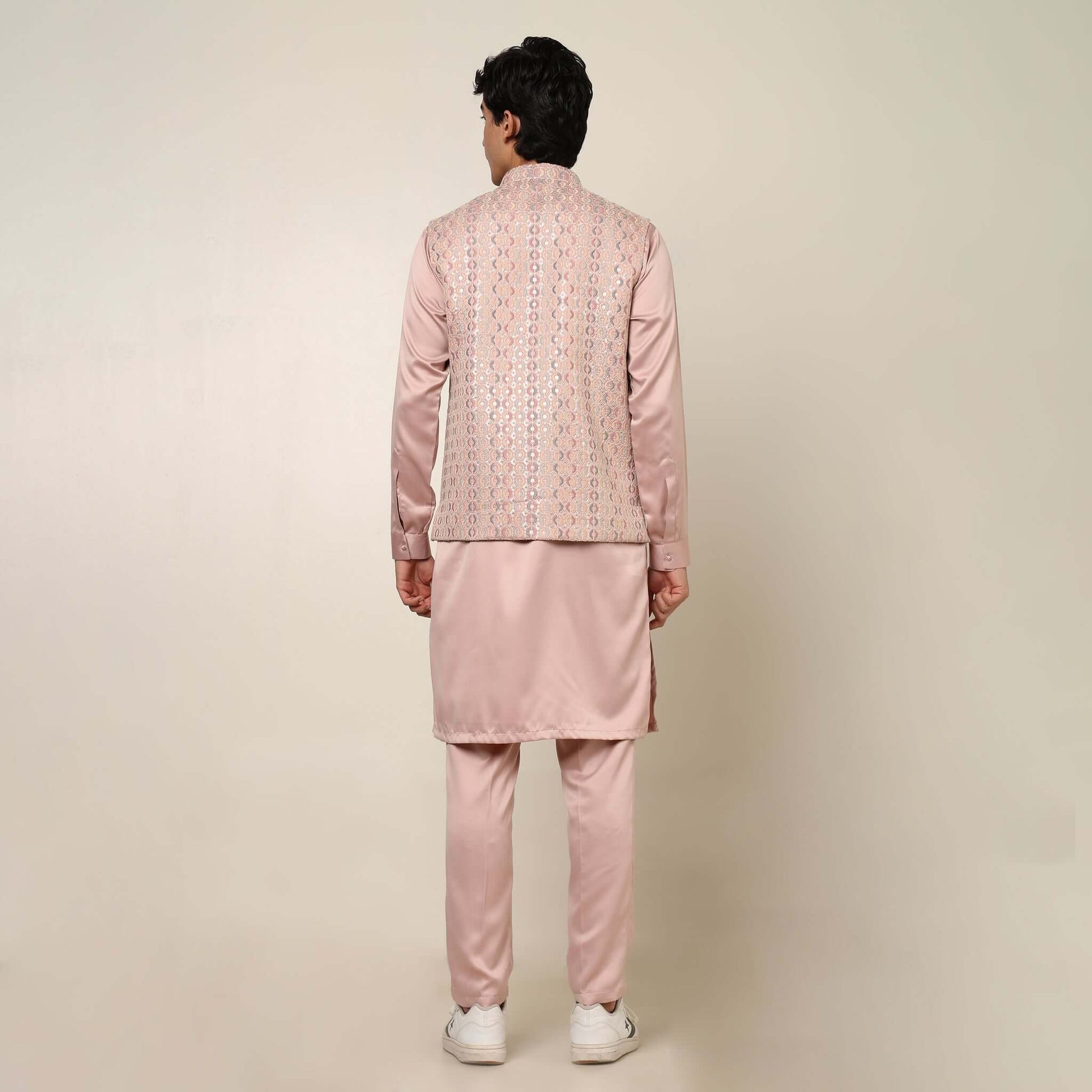 Peach kurta with nehru jacket for men which is made up of satin and has embroidery on it. Shop this peach designer wedding kurta jacket set for male from Crease India website.
