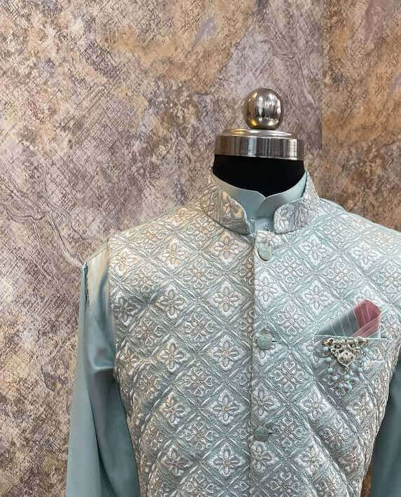Aqua Blue kurta with nehru jacket for men which is made up of satin and has floral zari work on it. Shop this aqua blue designer wedding kurta jacket set for male from Crease India website.