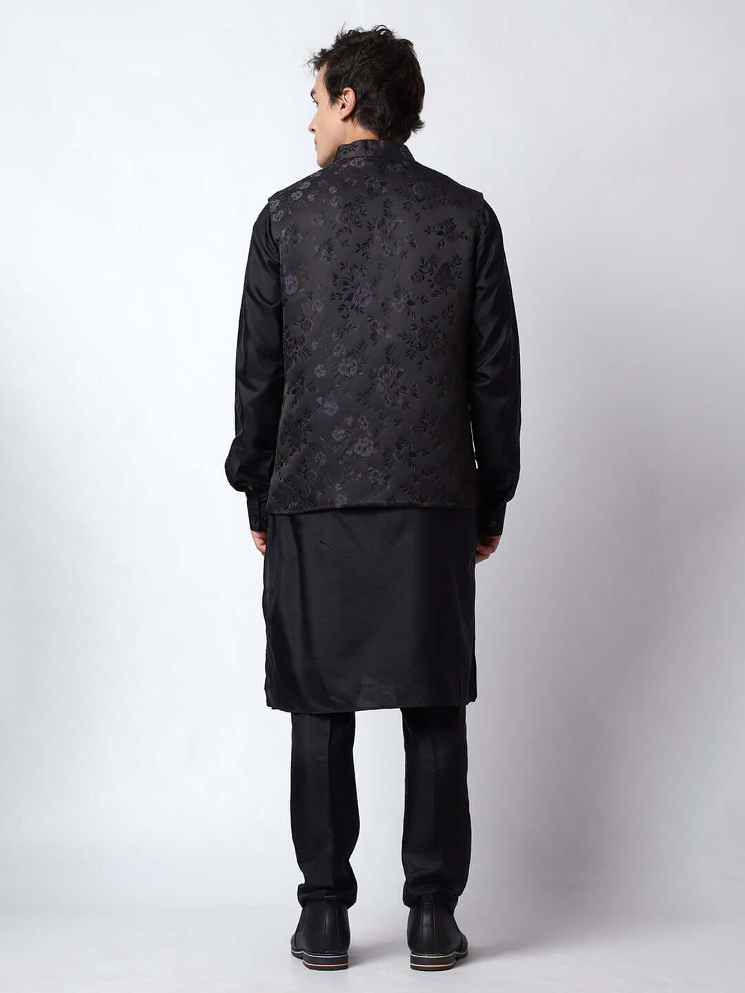 Black kurta with black nehru jacket for men which is made up of dupion silk and has motif designs on it. Shop this black designer wedding kurta jacket set for male from Crease India website.