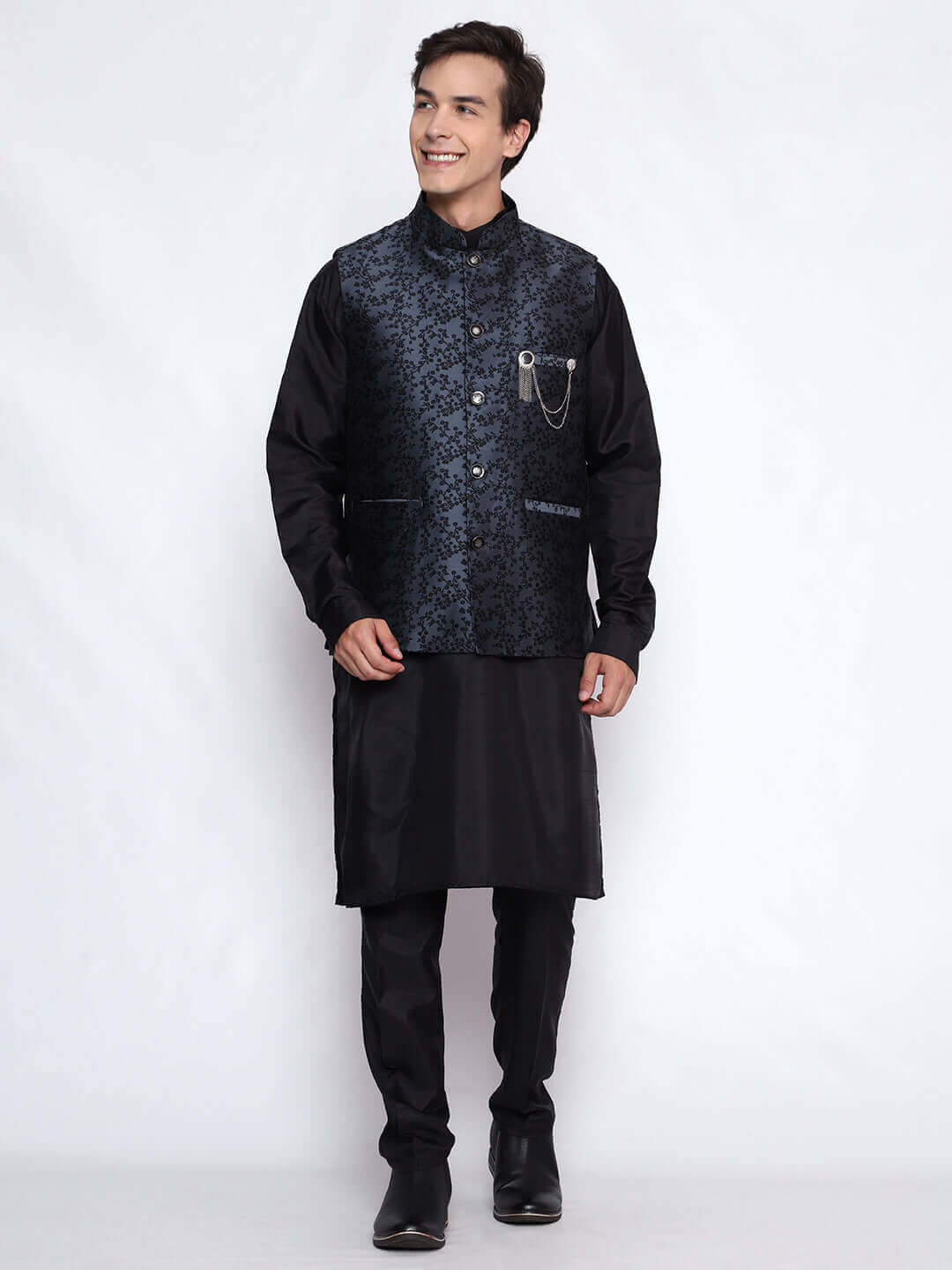 Black kurta with grey nehru jacket for men which is made up of jacquard silk and has floral embroidery on it. Shop this black designer wedding kurta jacket set for male from Crease India website.