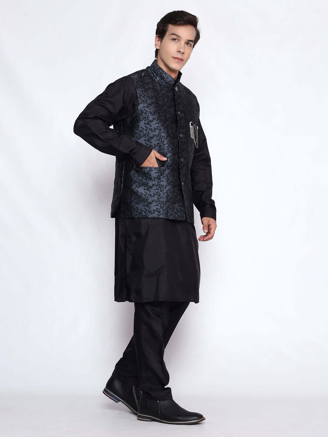 Black kurta with grey nehru jacket for men which is made up of jacquard silk and has floral embroidery on it. Shop this black designer wedding kurta jacket set for male from Crease India website.