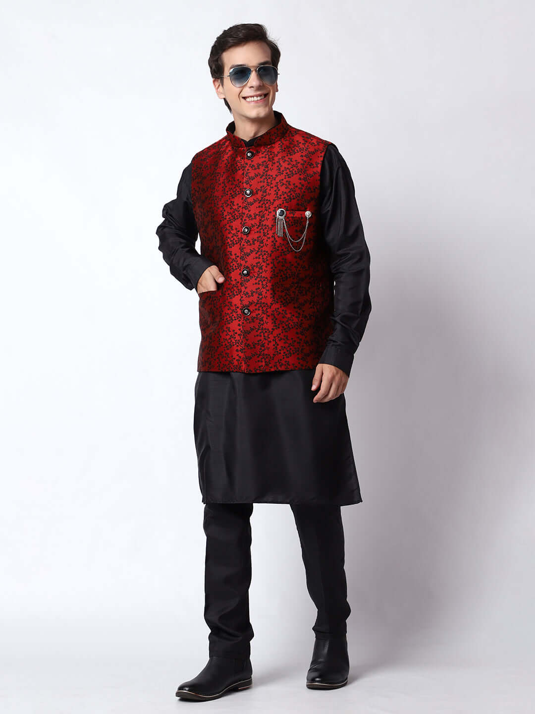 Black kurta with red nehru jacket for men which is made up of jacquard silk and has floral embroidery on it. Shop this black designer wedding kurta jacket set for male from Crease India website.