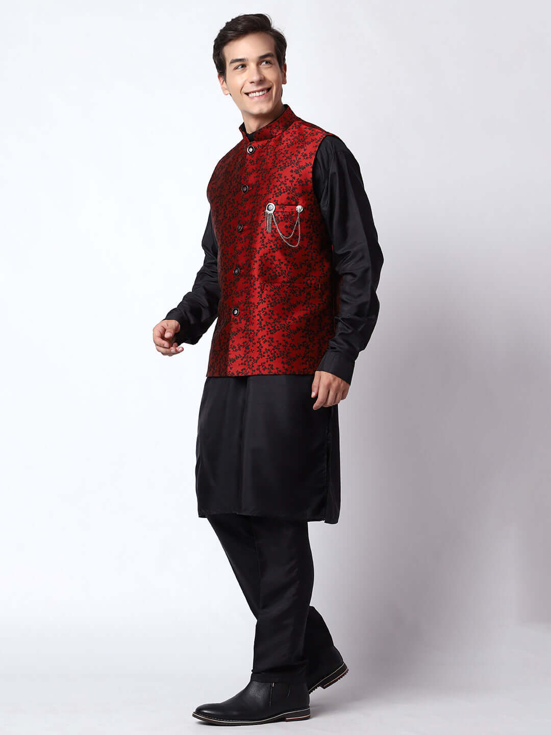 Black kurta with red nehru jacket for men which is made up of jacquard silk and has floral embroidery on it. Shop this black designer wedding kurta jacket set for male from Crease India website.