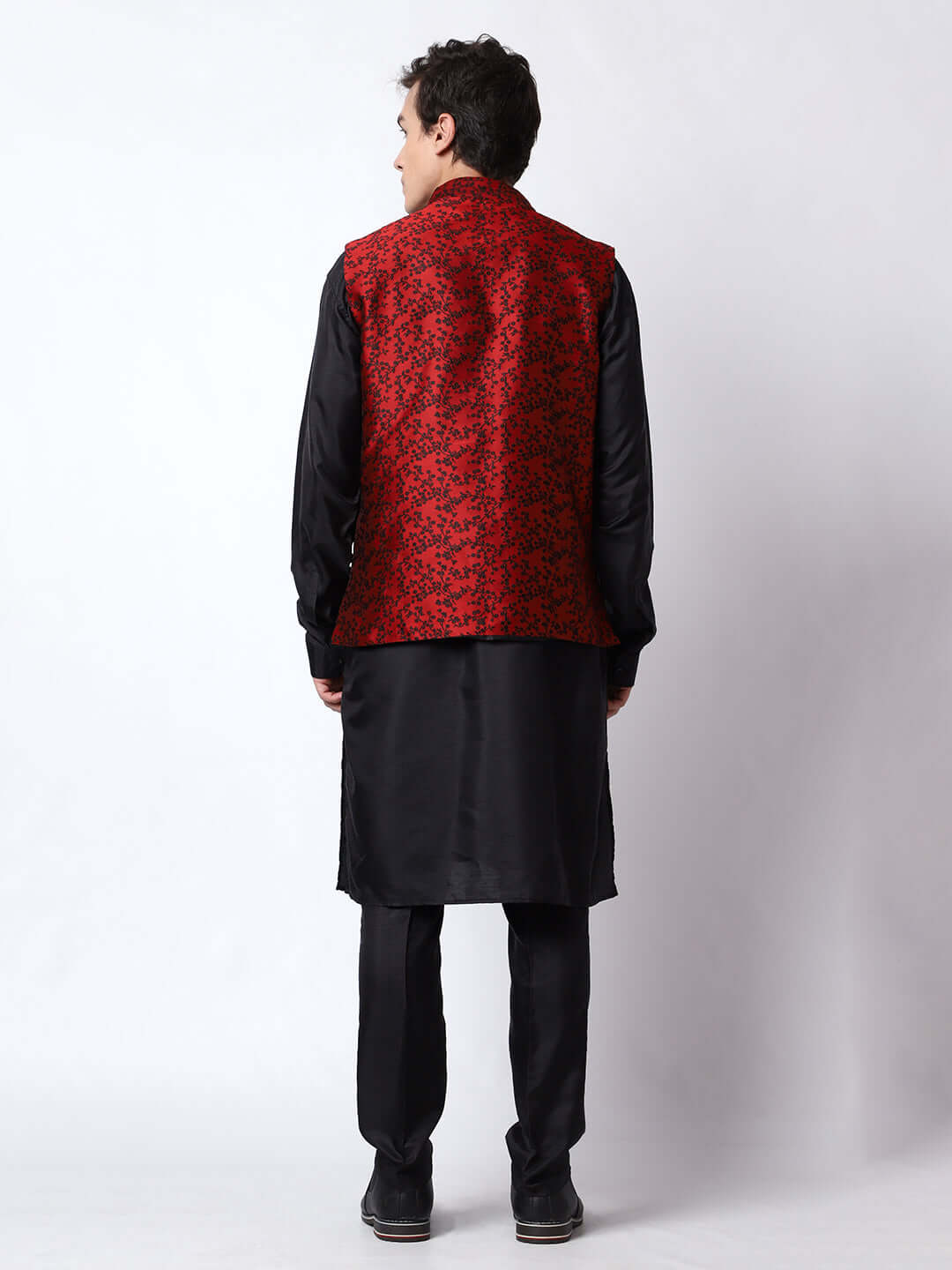 Black kurta with red nehru jacket for men which is made up of jacquard silk and has floral embroidery on it. Shop this black designer wedding kurta jacket set for male from Crease India website.