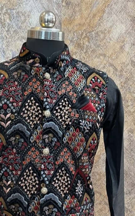 Black kurta with nehru jacket for men which is made up of velvet and has multicolored floral embroidery on it. Shop this black designer wedding kurta jacket set for male from Crease India website.
