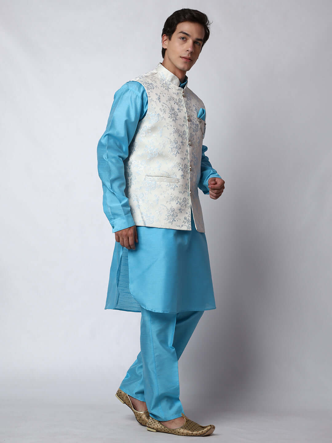Blue kurta with white nehru jacket for men which is made up of jacquard silk and has floral motifs on it.  Shop this designer wedding kurta jacket set for male from Crease India website.