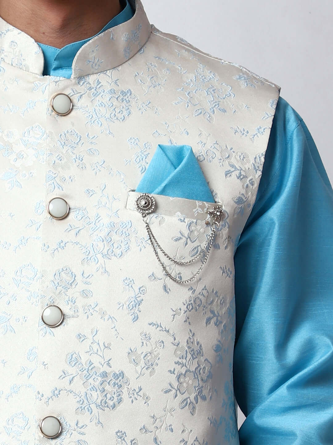 Blue kurta with white nehru jacket for men which is made up of jacquard silk and has floral motifs on it.  Shop this designer wedding kurta jacket set for male from Crease India website.