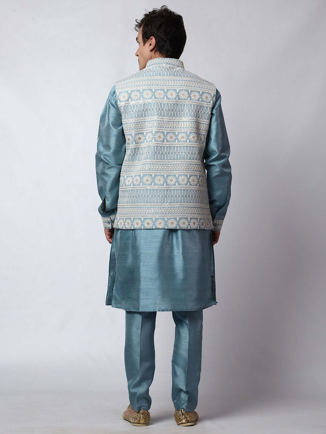 Turquoise Blue kurta with blue nehru jacket for men which is made up of dupion silk and has net embroidery with sequins on it. Shop this turquoise blue designer wedding kurta jacket set for male from Crease India website.