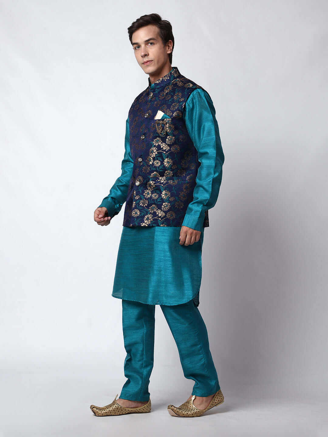 Turquoise Blue kurta with midnight blue nehru jacket for men which is made up of dupion silk and has golden floral embroidery on it. Shop this turquoise blue designer wedding kurta jacket set for male from Crease India website.
