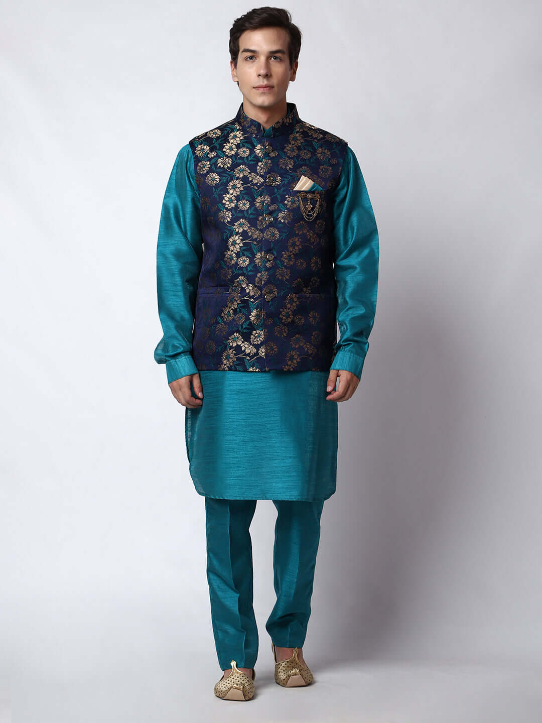 Turquoise Blue kurta with midnight blue nehru jacket for men which is made up of dupion silk and has golden floral embroidery on it. Shop this turquoise blue designer wedding kurta jacket set for male from Crease India website.