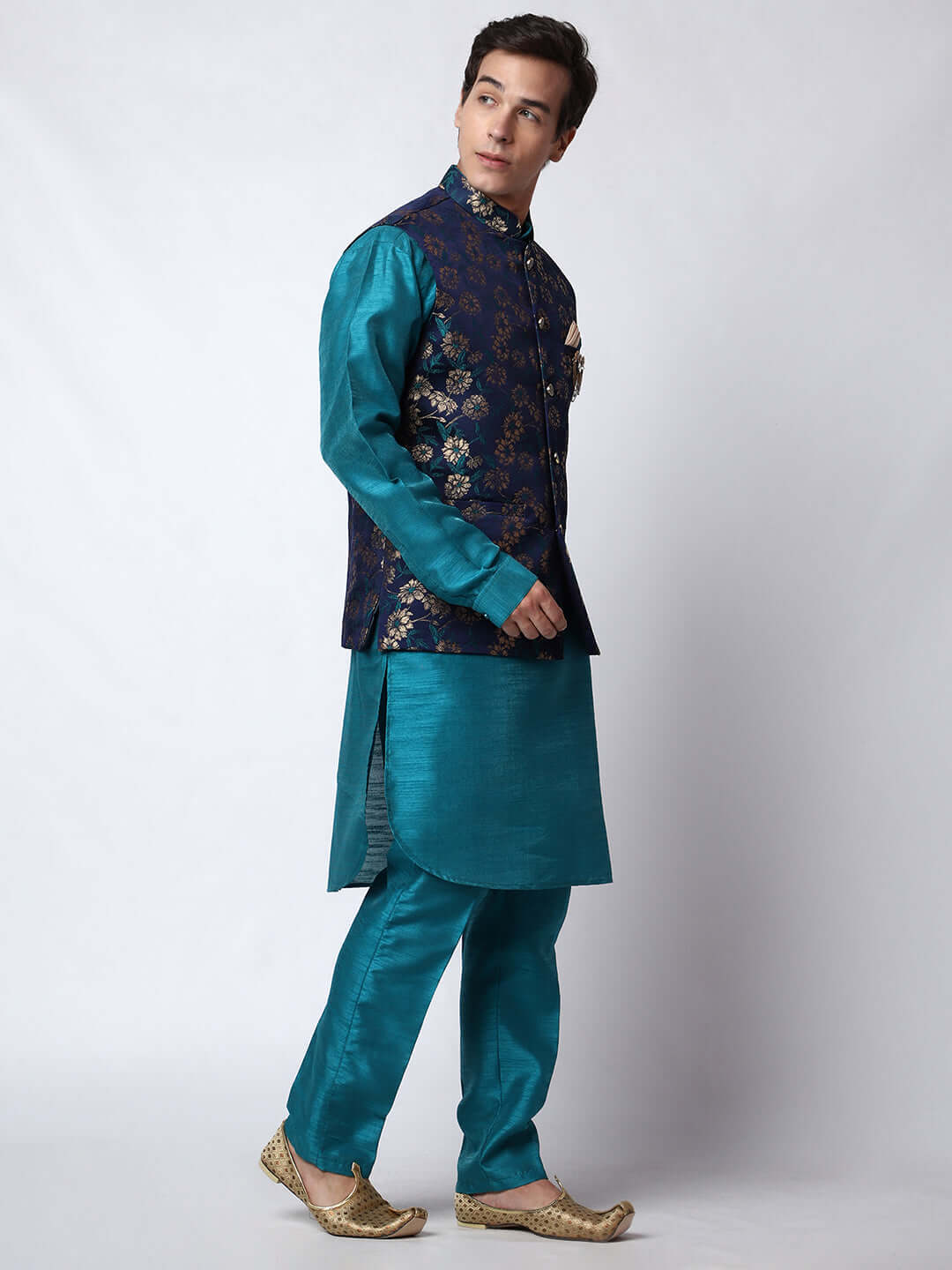 Turquoise Blue kurta with midnight blue nehru jacket for men which is made up of dupion silk and has golden floral embroidery on it. Shop this turquoise blue designer wedding kurta jacket set for male from Crease India website.
