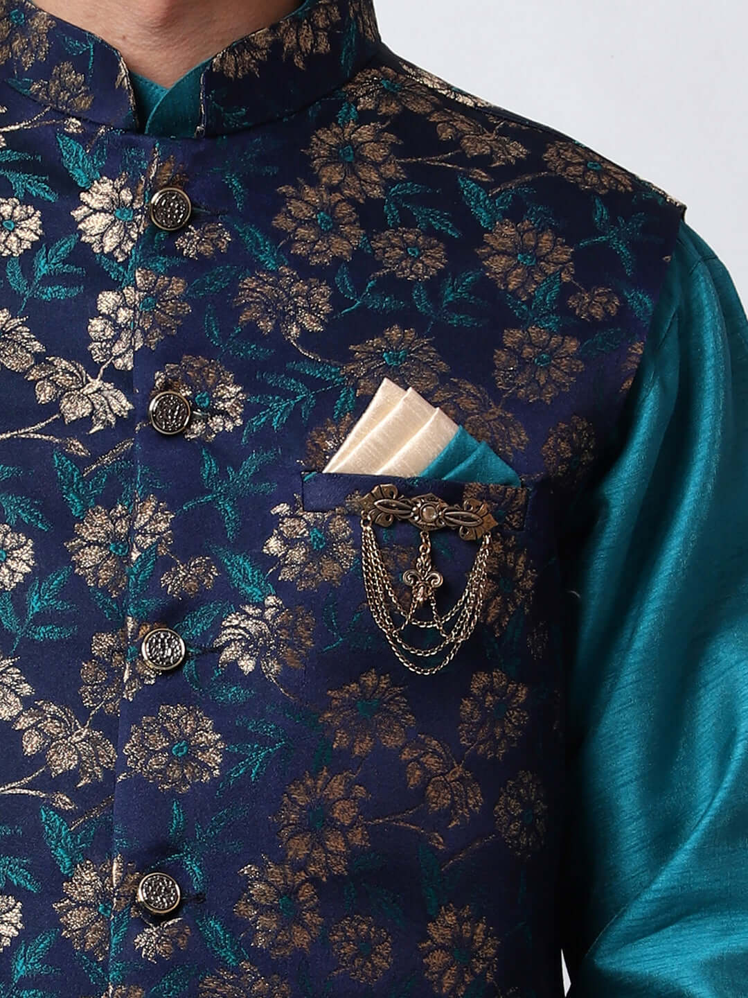 Turquoise Blue kurta with midnight blue nehru jacket for men which is made up of dupion silk and has golden floral embroidery on it. Shop this turquoise blue designer wedding kurta jacket set for male from Crease India website.