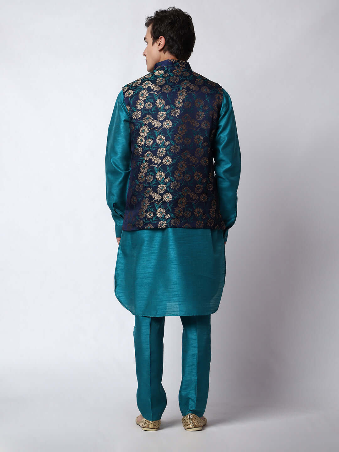 Turquoise Blue kurta with midnight blue nehru jacket for men which is made up of dupion silk and has golden floral embroidery on it. Shop this turquoise blue designer wedding kurta jacket set for male from Crease India website.