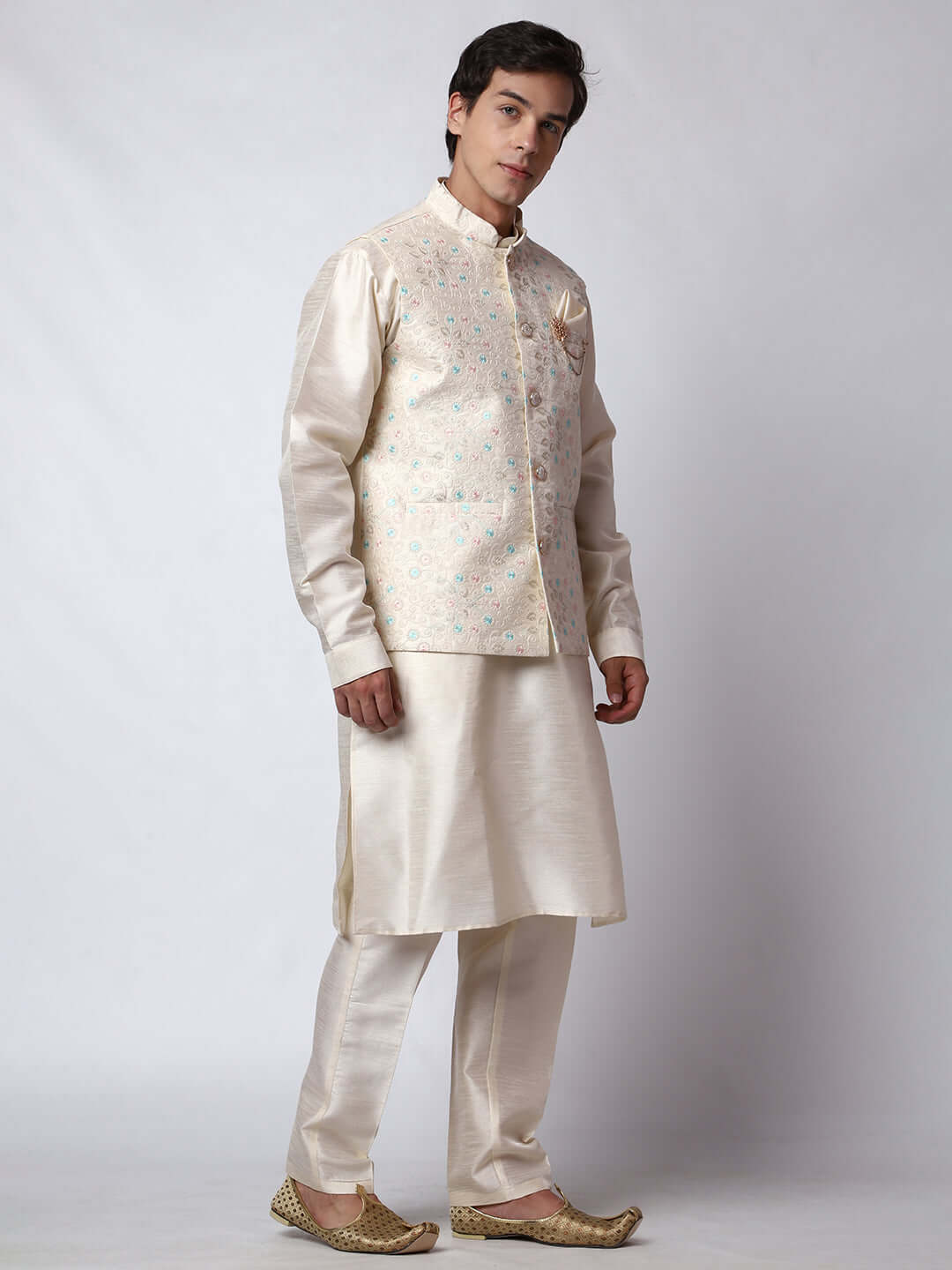 Cream kurta with nehru jacket for men which is made up of dupion silk and has multicolored thread embroidery on it. Shop this cream designer wedding kurta jacket set for male from Crease India website.