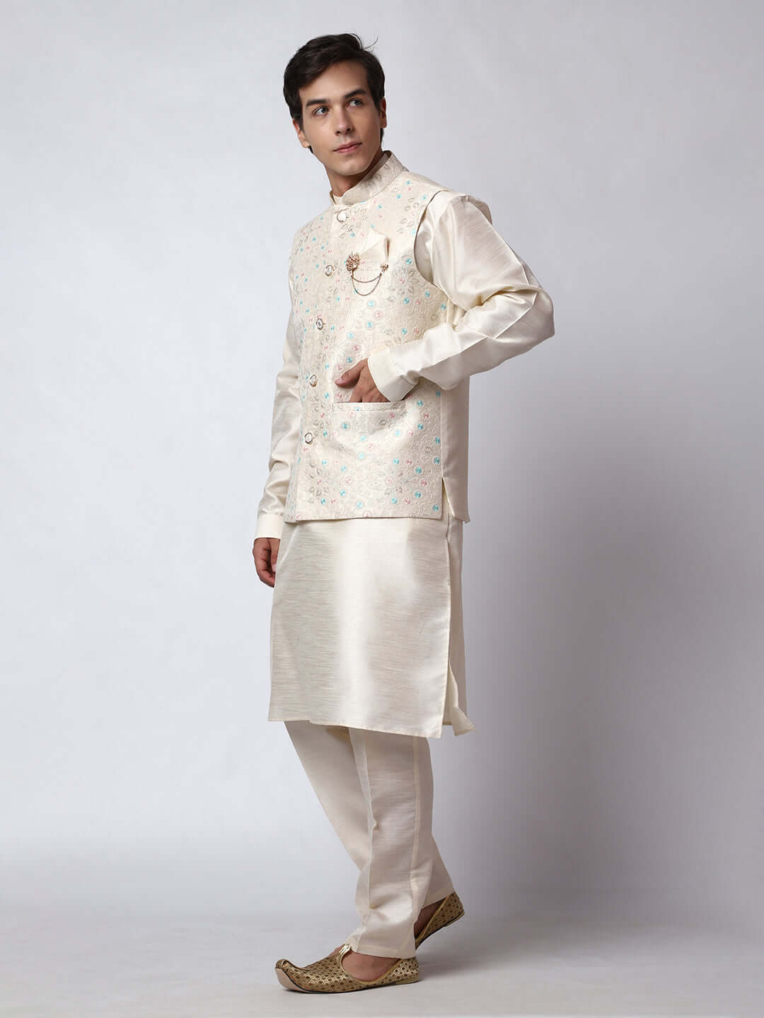 Cream kurta with nehru jacket for men which is made up of dupion silk and has multicolored thread embroidery on it. Shop this cream designer wedding kurta jacket set for male from Crease India website.