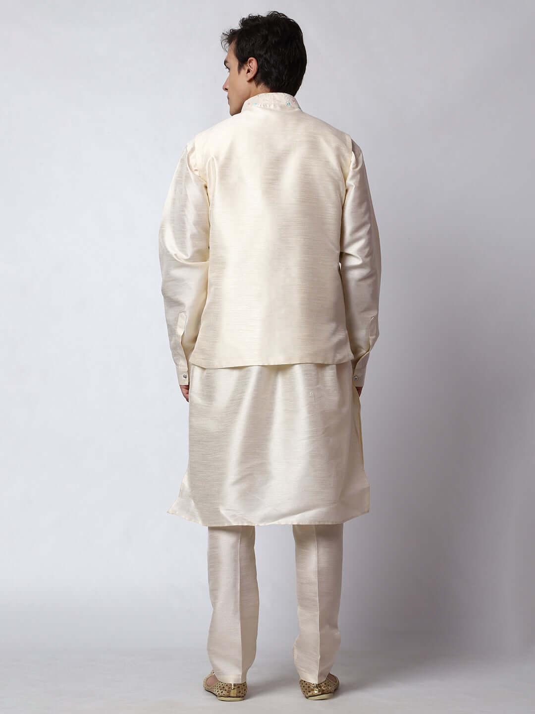 Cream kurta with nehru jacket for men which is made up of dupion silk and has multicolored thread embroidery on it. Shop this cream designer wedding kurta jacket set for male from Crease India website.