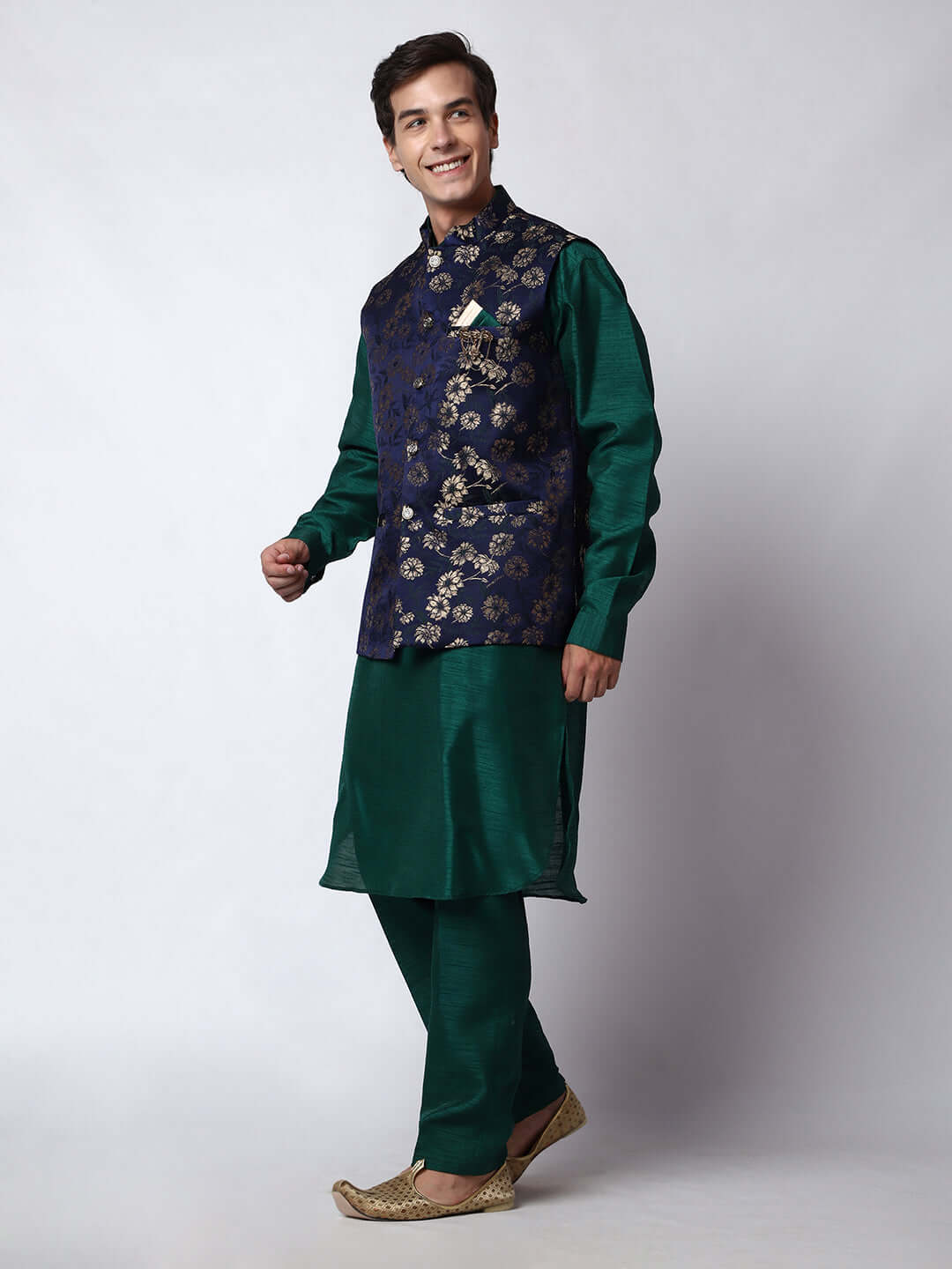 Dark Green kurta with midnight blue nehru jacket for men which is made up of dupion silk and has golden floral embroidery on it. Shop this dark green designer wedding kurta jacket set for male from Crease India website.
