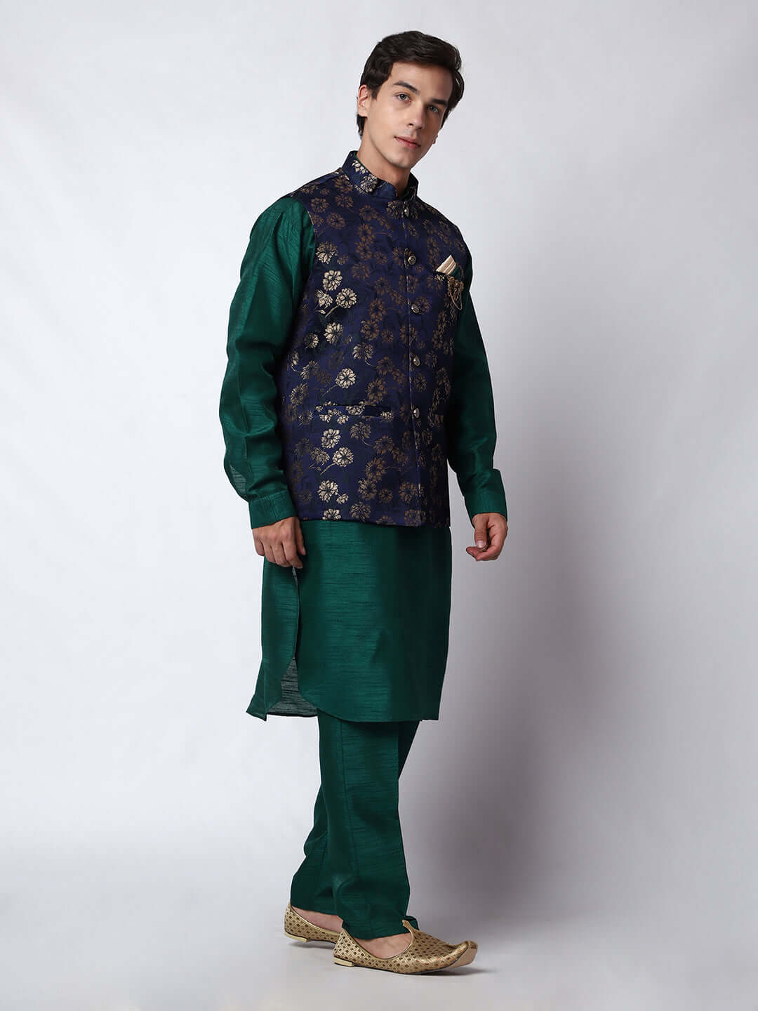 Dark Green kurta with midnight blue nehru jacket for men which is made up of dupion silk and has golden floral embroidery on it. Shop this dark green designer wedding kurta jacket set for male from Crease India website.