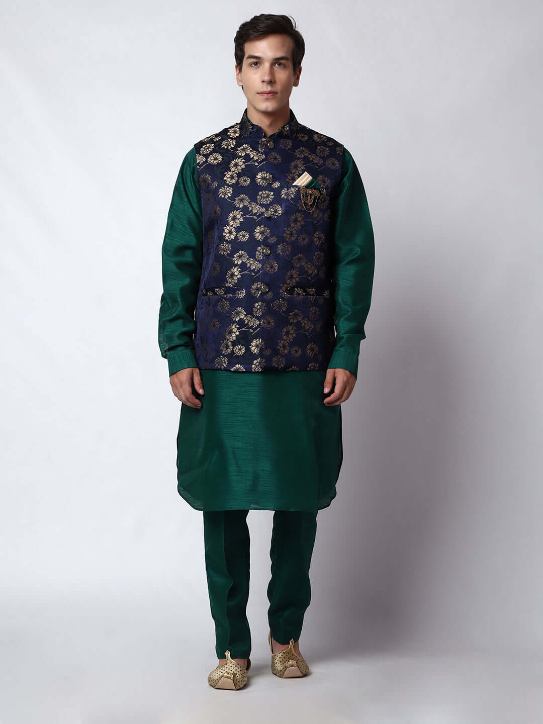 Dark Green kurta with midnight blue nehru jacket for men which is made up of dupion silk and has golden floral embroidery on it. Shop this dark green designer wedding kurta jacket set for male from Crease India website.