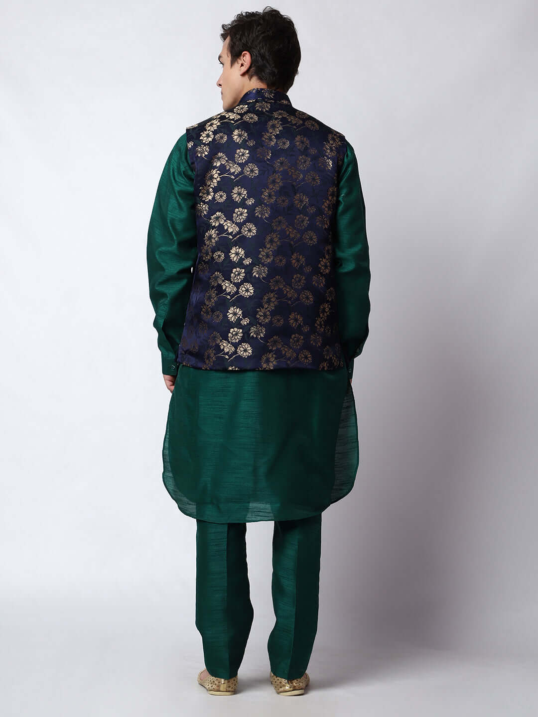 Dark Green kurta with midnight blue nehru jacket for men which is made up of dupion silk and has golden floral embroidery on it. Shop this dark green designer wedding kurta jacket set for male from Crease India website.