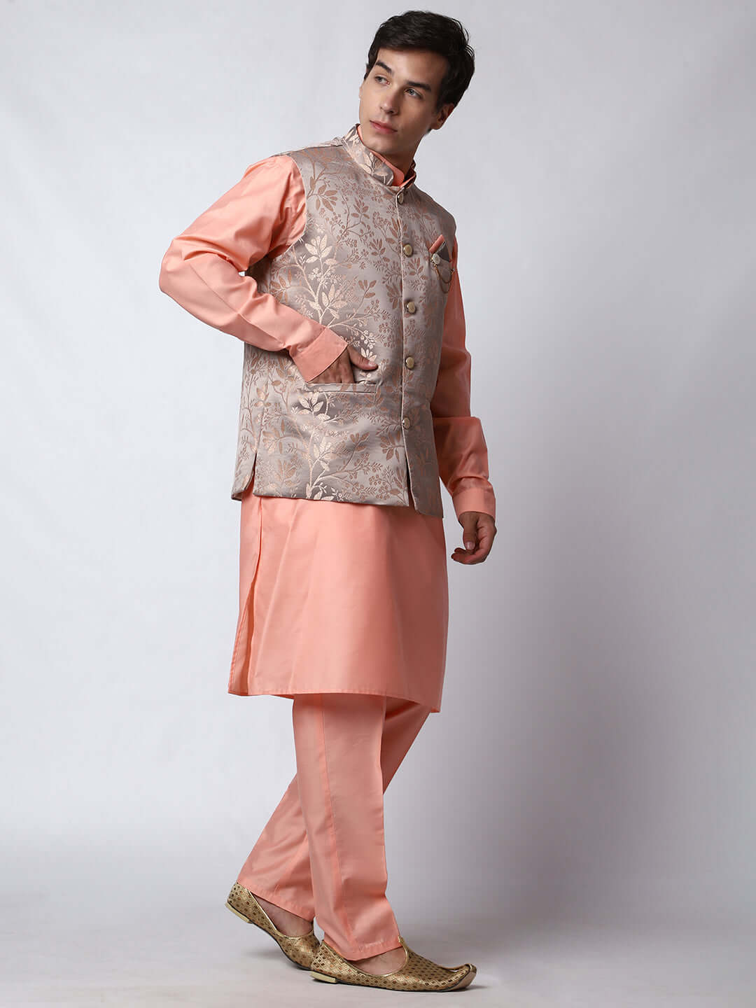 Peach kurta with grey nehru jacket for men which is made up of satin jacquard and has floral embroidery on it. Shop this peach designer wedding kurta jacket set for male from Crease India website.