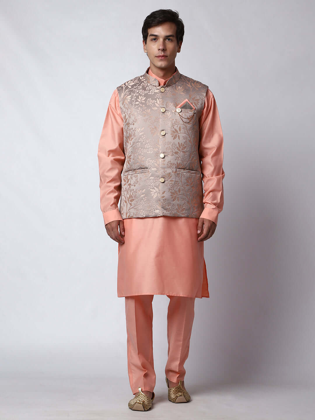Peach kurta with grey nehru jacket for men which is made up of satin jacquard and has floral embroidery on it. Shop this peach designer wedding kurta jacket set for male from Crease India website.