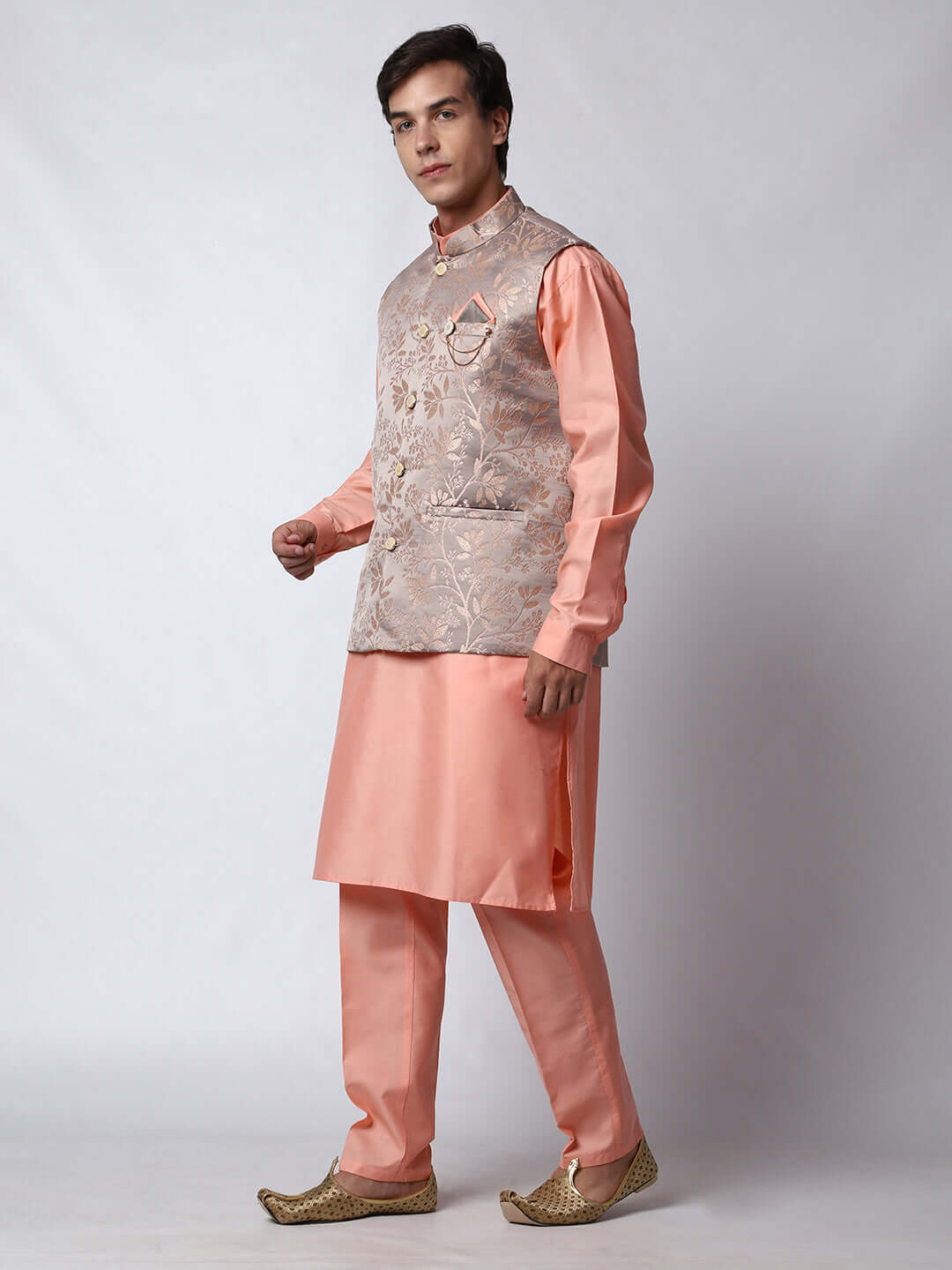 Peach kurta with grey nehru jacket for men which is made up of satin jacquard and has floral embroidery on it. Shop this peach designer wedding kurta jacket set for male from Crease India website.
