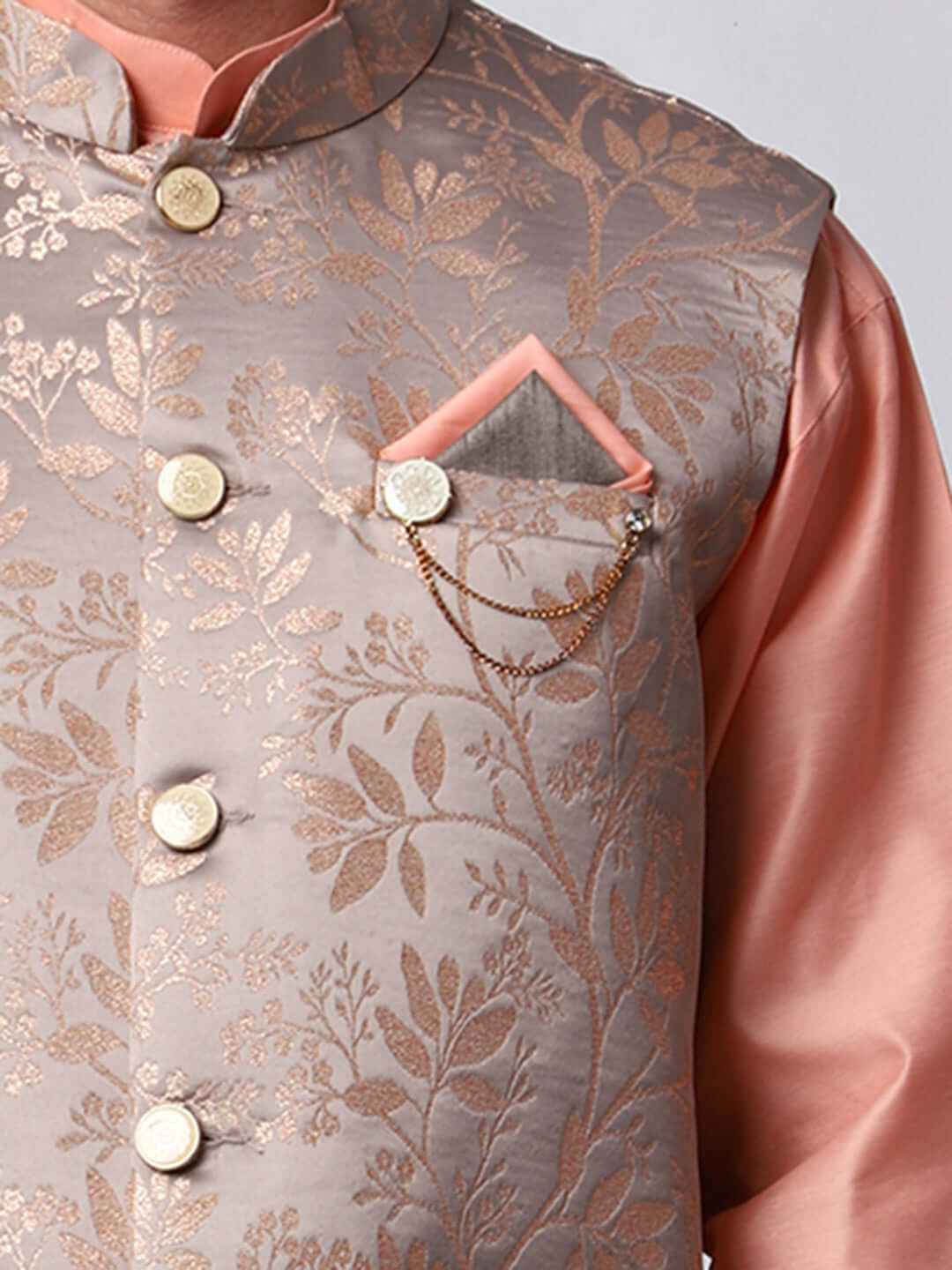 Peach kurta with grey nehru jacket for men which is made up of satin jacquard and has floral embroidery on it. Shop this peach designer wedding kurta jacket set for male from Crease India website.