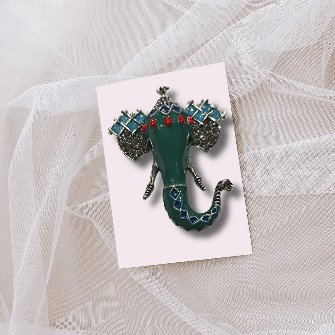 Men's Green Ganesha Brooch Lapel Pin on a light background, designed for tuxedos and traditional Indian wear.