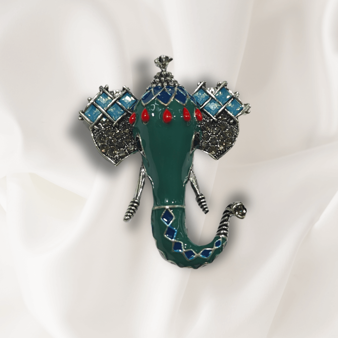 Men's Green Ganesha Brooch Lapel Pin featuring intricate enamel detailing on a silk background.