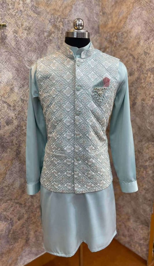 Aqua Blue kurta with nehru jacket for men which is made up of satin and has floral zari work on it. Shop this aqua blue designer wedding kurta jacket set for male from Crease India website.