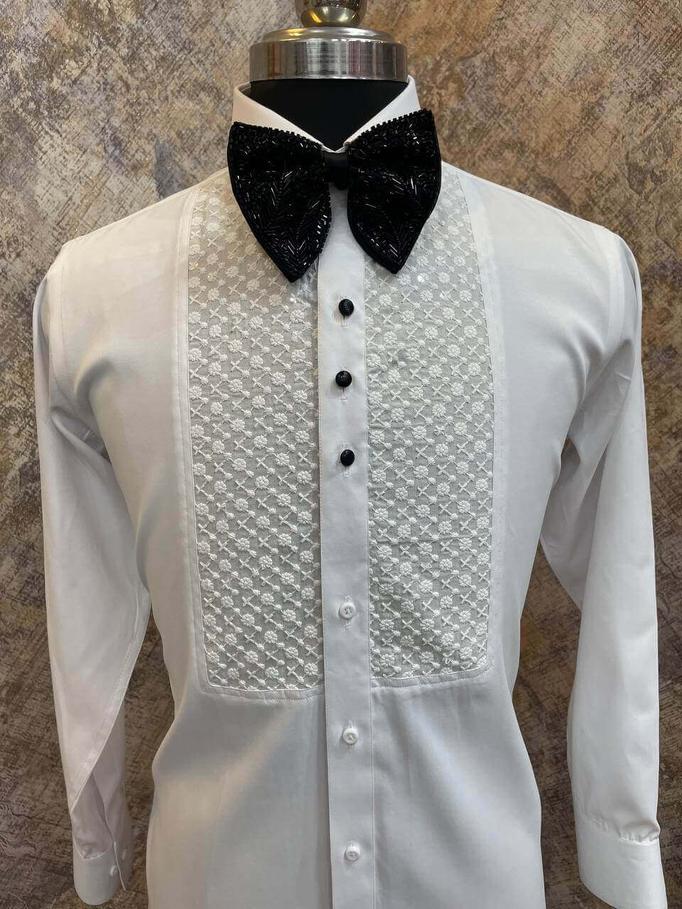 Chikankari Designer White Tuxedo Shirt for Men which is made up of cotton and has chikankari work at the front. Perfect designer formal wear white shirt for weddings and black tie events by Crease India.