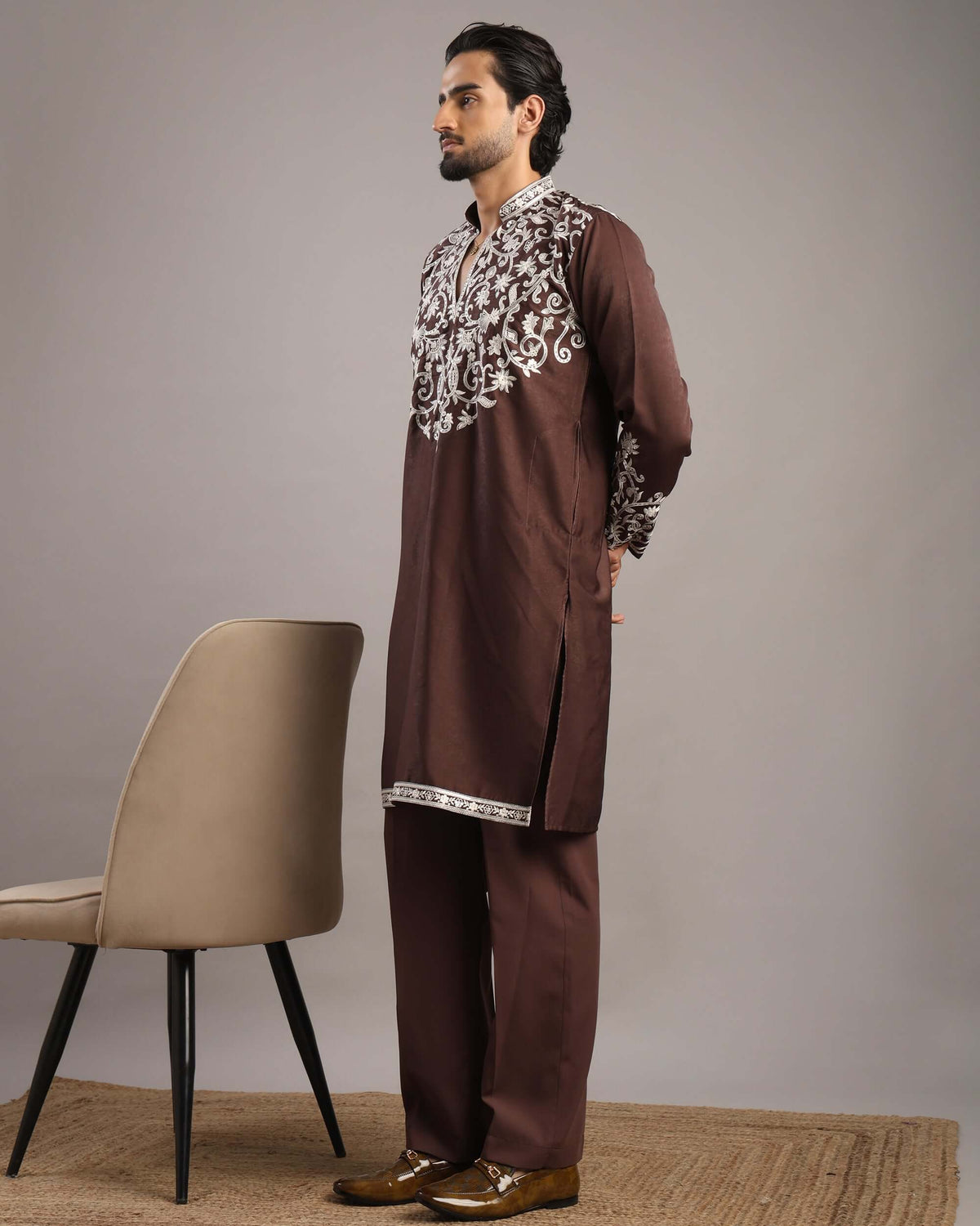 Model posing to his right in Men’s Burgundy Royale Floral Embroidered Kurta by Crease India