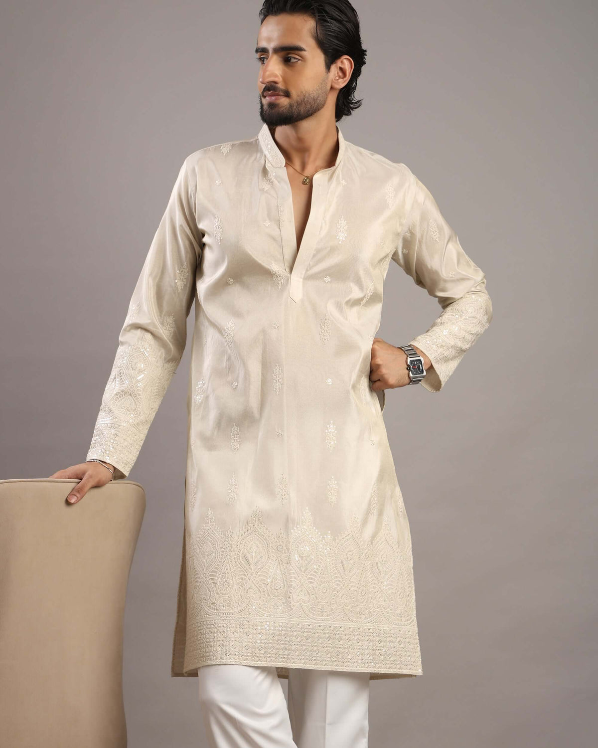 Model posing to his right in Men’s Cream Royale Floral Embroidered Kurta by Crease India