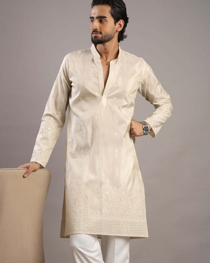 Model posing to his right in Men’s Cream Royale Floral Embroidered Kurta by Crease India