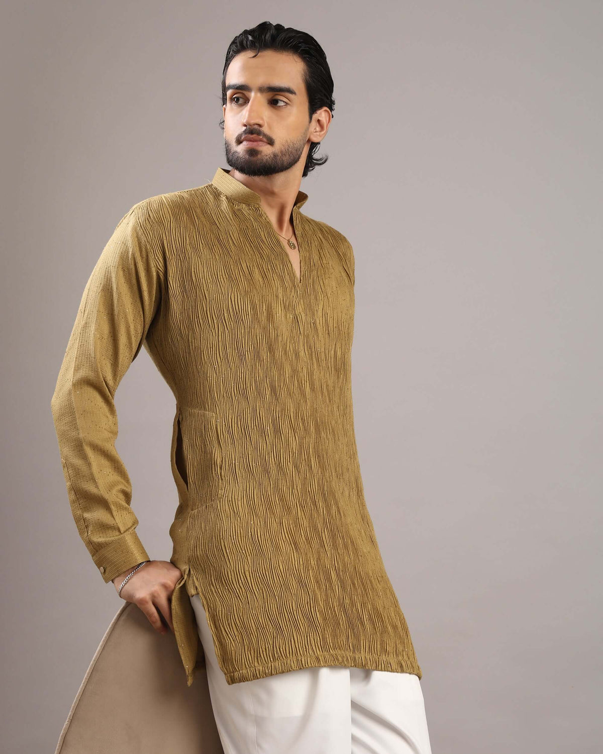 Model posing to his right in Men’s Mustard Gold V-Neck Pleated Party Wear Kurta by Crease India