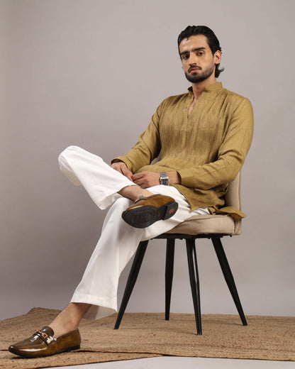 Model sitting in chair posing front in Men’s Mustard Gold V-Neck Pleated Party Wear Kurta by Crease India