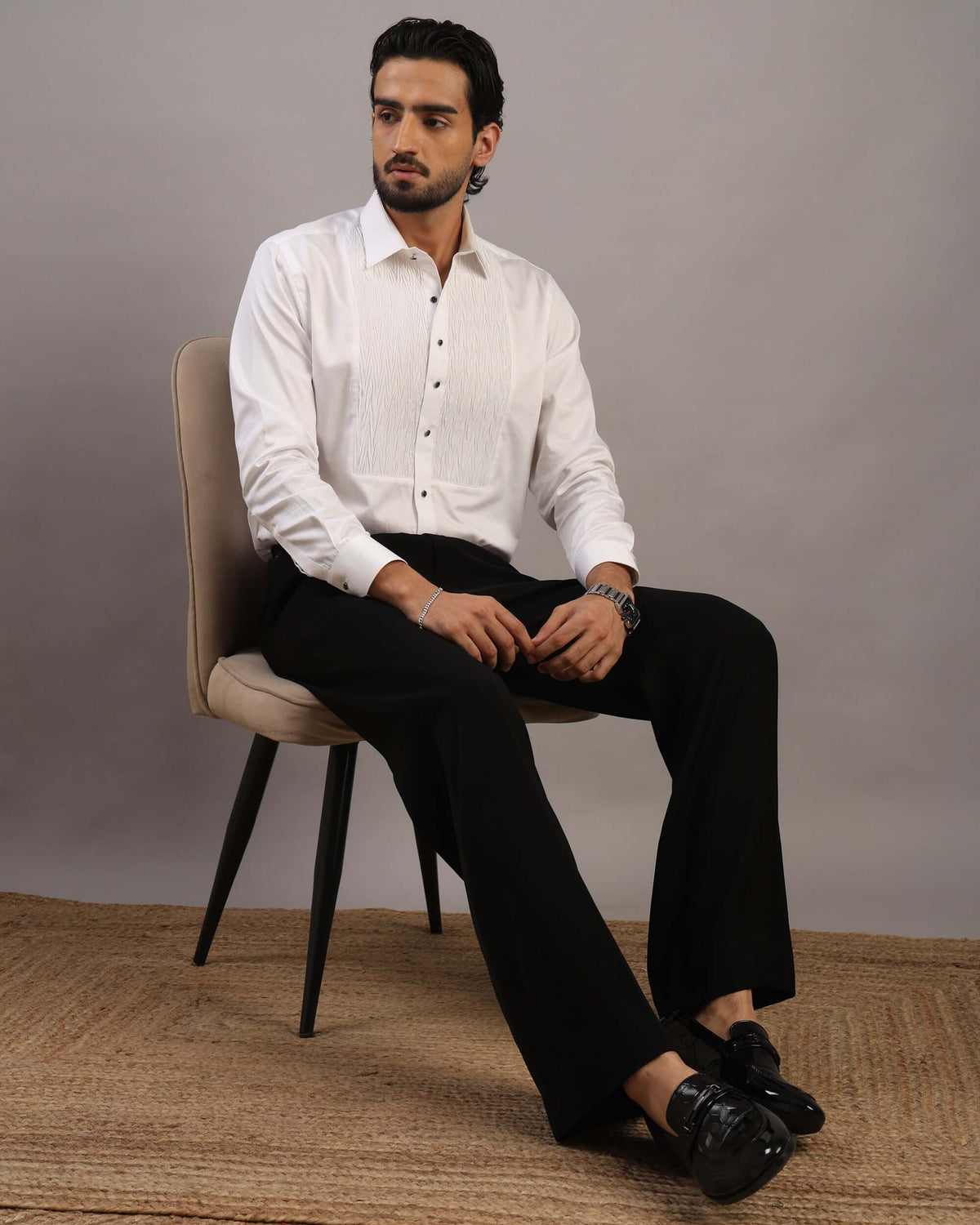 Model sitting in chair wearing Men’s Ripple White Formal Tuxedo Shirt by Crease India
