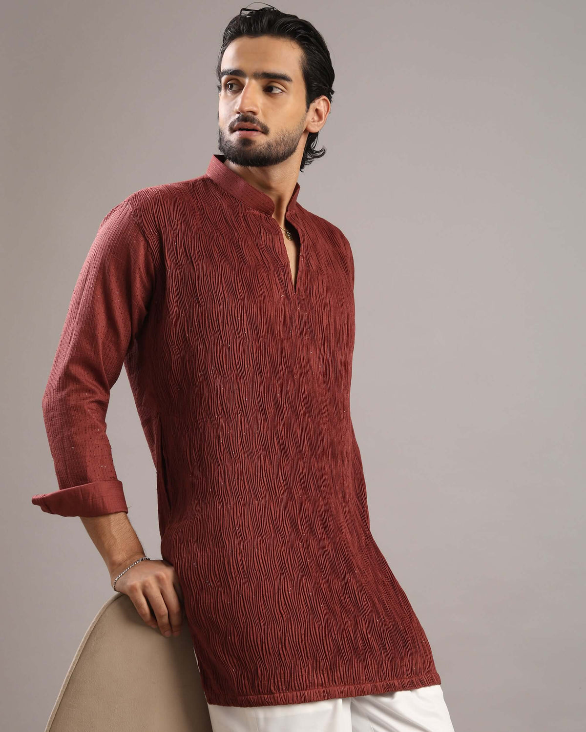 Model posing to his right in Men’s Rust Red V-Neck Pleated Party Wear Kurta by Crease India