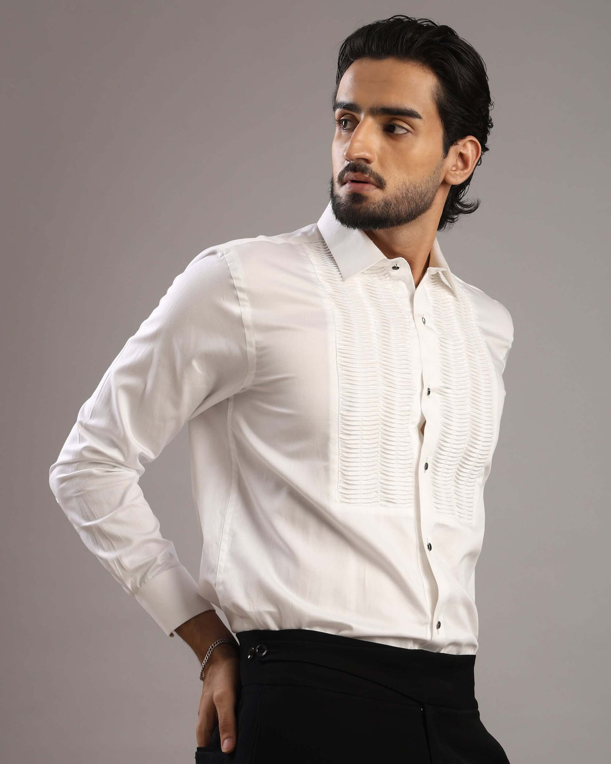 Model looking to his right in Men’s White Accordion Pleated Tuxedo Shirt by Crease India
